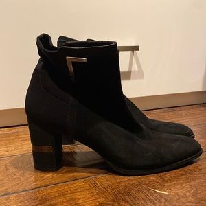 Dress up in the se black suede ankle booties by Stuart Weitzman